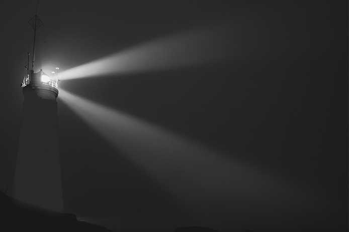 An Icelandic lighthouse in the moody dark night. Abstract image, dark mood. Iceland
